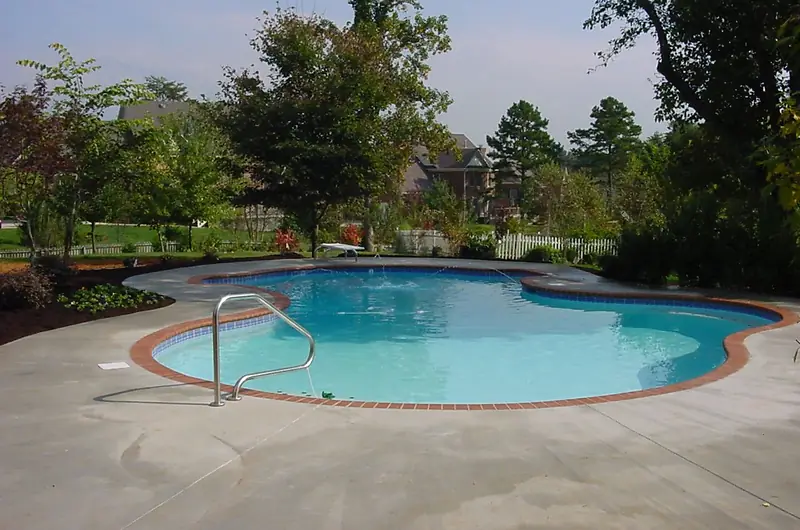 A refinished Sequoyah pool, the surface renewed and the coping reset.