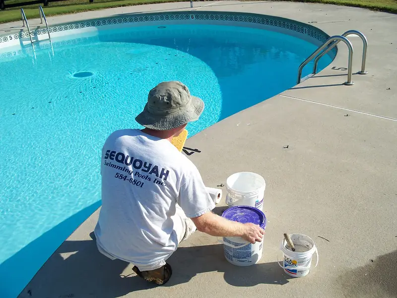 Repair work under way at the edge of a client's pool in Knoxville.