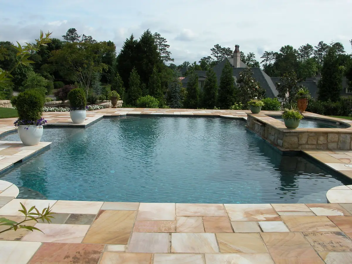 A Sequoyah Pools gunite pool set into lawn with the Tennessee hills beyond.